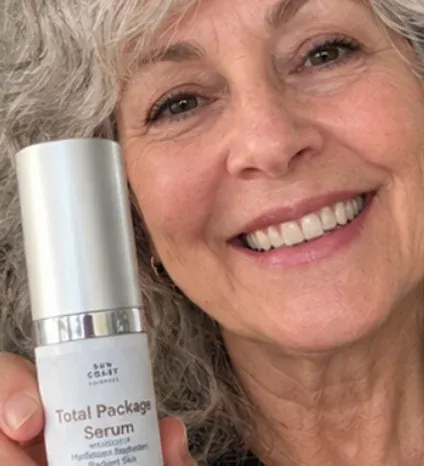 Customer holding her Total Package Serum